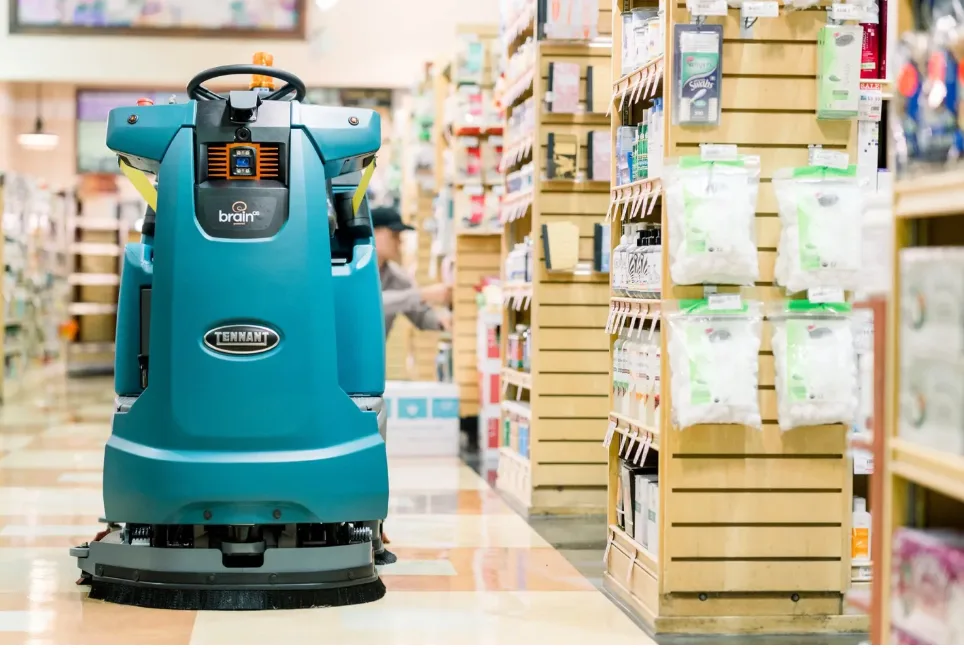 An autonomous floor scrubbing robot in action at a Sam’s Club location. AI market research can lead to new innovations like these to reduce costs and labor-intensive tasks that were once manual.