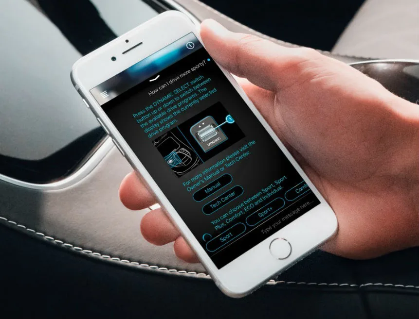 An image of a hand holding an iPhone with the Ask Mercedes AI app loaded. The question asked and displayed on the app is “How can I drive more sporty?” with detailed answers and diagrams provided by the app. Ask Mercedes is a key example of a major brand leveraging AI business transformation opportunities.