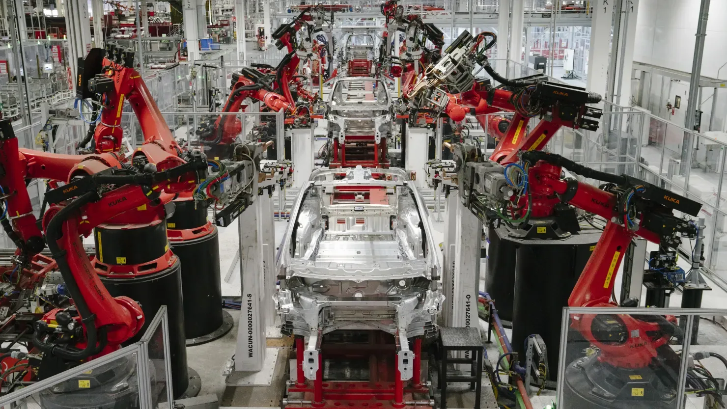 An AI agent example showcasing robots enhancing efficiency at the Tesla factory.