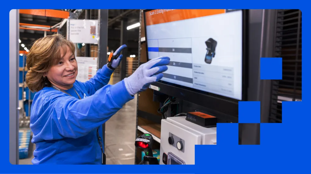 Walmart associate using AI-powered supply chain technology in a distribution center, an example of enterprise AI integration, wiring AI decisions directly into frontline operations.
